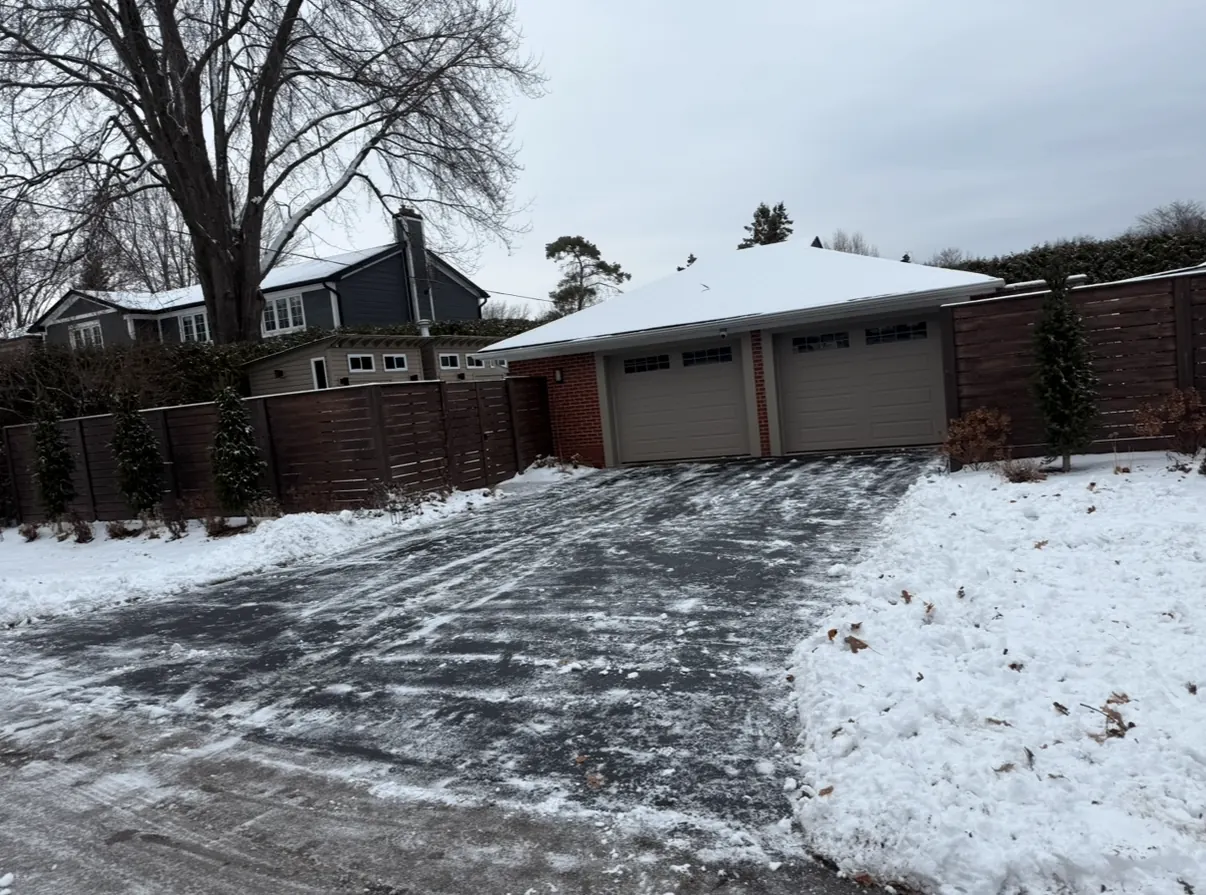 Cleared asphalt driveway after a snowfall